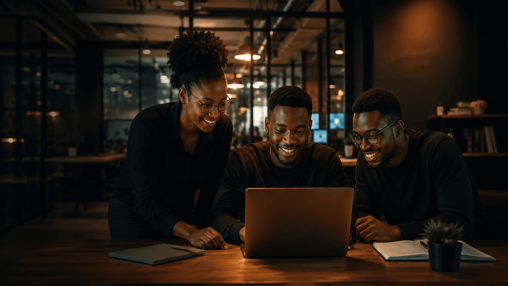 Team members working together around a laptop